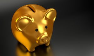 A gold piggy bank on a black background.